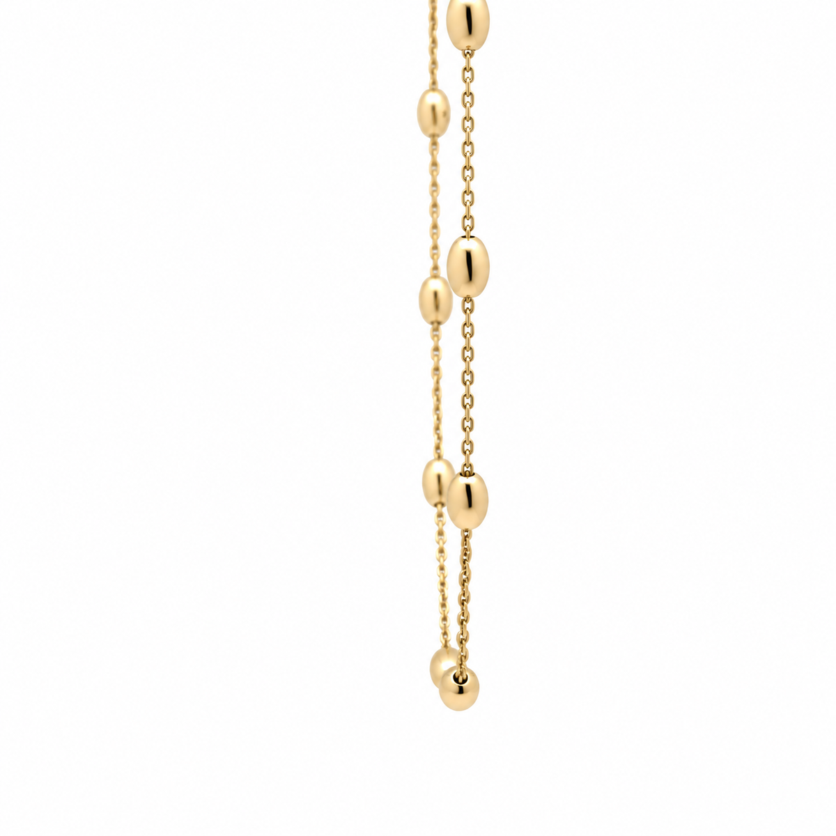Close-up of polished oval gold beads spaced along a fine 14KT yellow gold necklace chain.