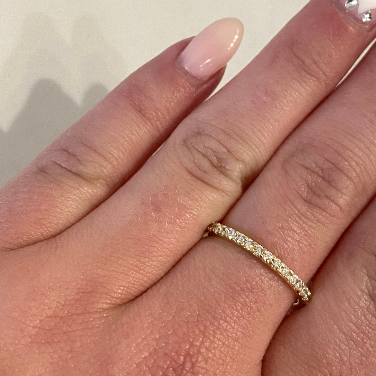 AD98 Diamond Shared Prong Eternity Band worn on hand
